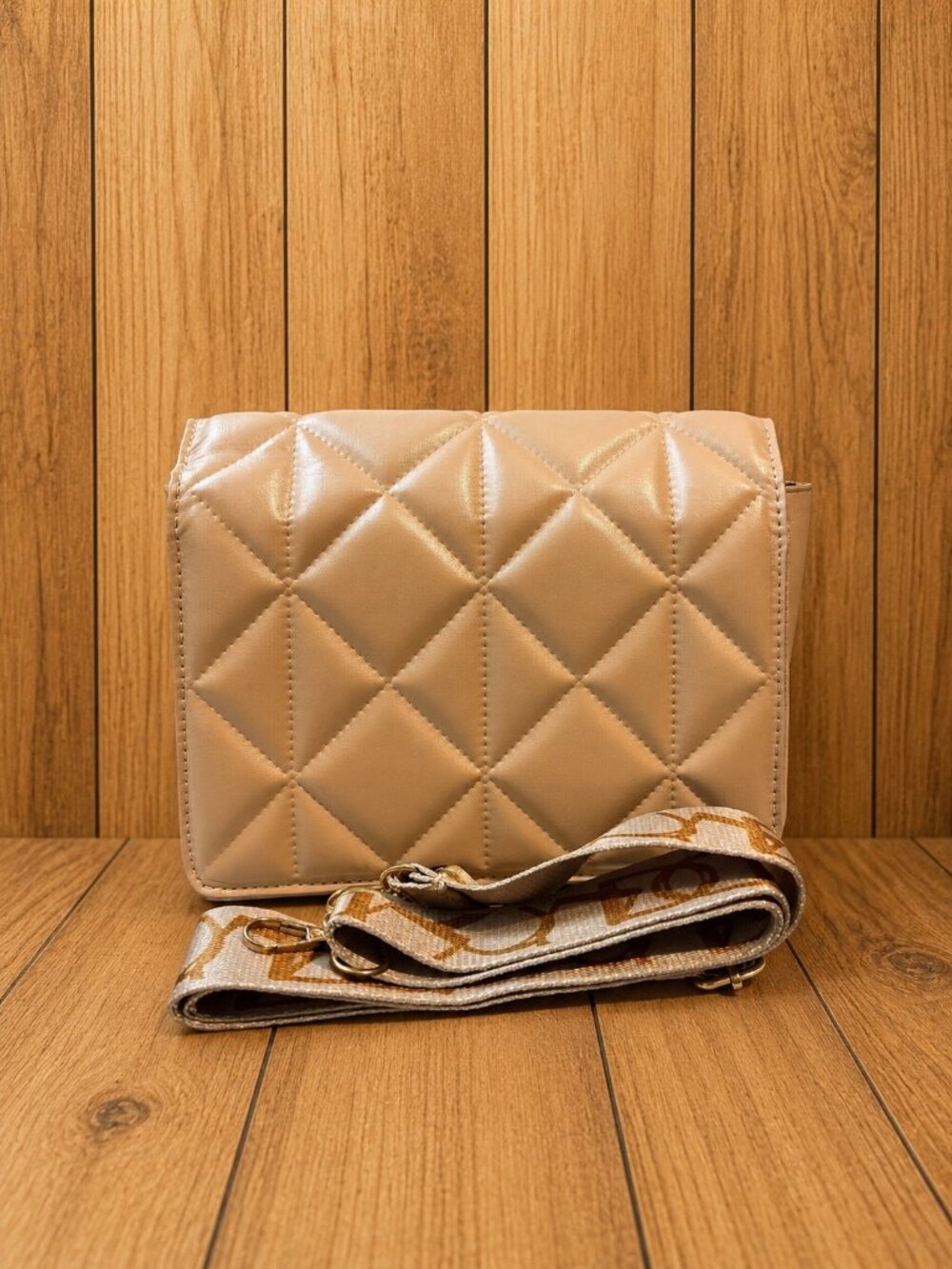 Tan quilted flap handbag featuring a soft diamond pattern, gold-tone hardware